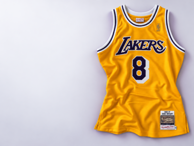 Gold Los Angeles Lakers number 8 basketball jersey on a pale studio background